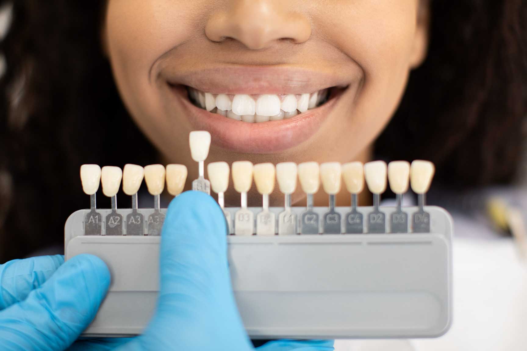 Dentist Choosing Right Emanel Color For Female Patient